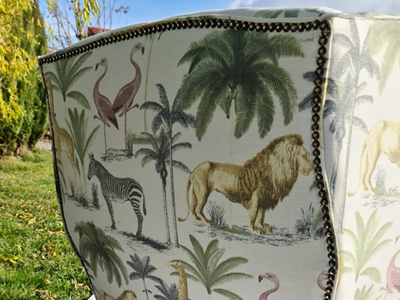 armchair recovered in jungle fabric