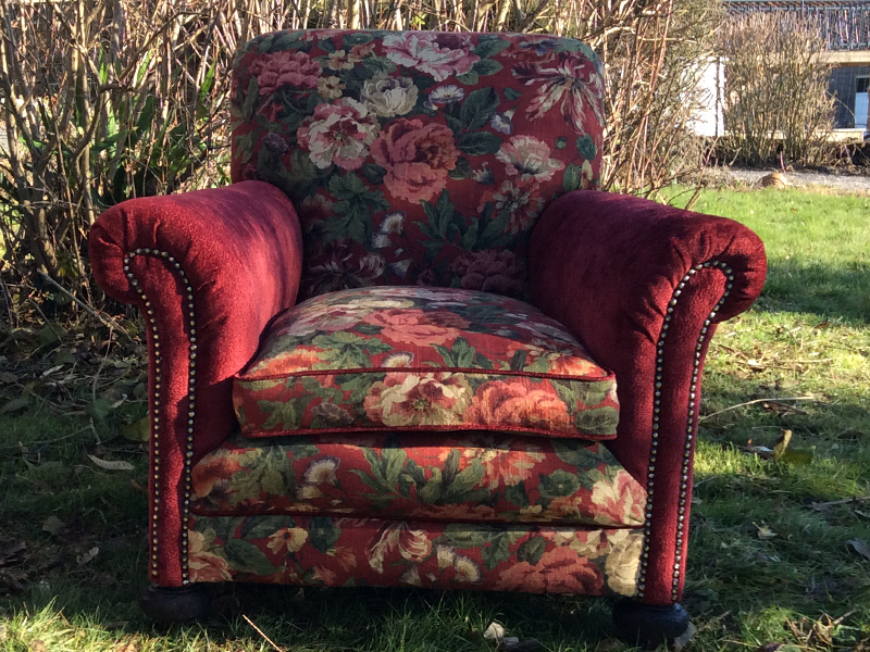 red and floral fabric used to recover this armchair